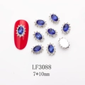 Macro shot of 7x10mm oval blue crystal nail charms with small diamond halo and metal base - 3088 Royal Blue Oval (LF3088)