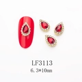 Macro detail of red pear-shaped nail charm with gold base and white crystal border - 3113 Bright Red Gold Base Teardrop (LF3113)