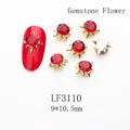 Macro detail of red K9 crystal nail jewelry with gold sunburst setting 9x10.5mm size - 3110 Bright Red Gold Base Gem Flower (LF3110)