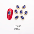 Macro view of blue oval nail gems with rhinestones in gold setting 7x10mm - 3095 Royal Blue Gold Base Oval (LF3095)