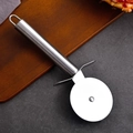 Stainless steel pizza cutter wheel with round handle on a dark stone tabletop - Single Wheel Pizza Cutter
