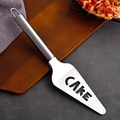 Stainless steel cake server with hollow handle and CAKE cutout on dark wooden board - Hollow CAKE Letter Shovel