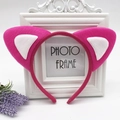 Close-up of pink and white plush cat ears headband on a decorative photo frame - Rose Red with White Cat Ears