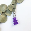 Translucent purple resin gummy bear keychain with silver alloy clasp on white background - Single Bear Pendant / Purple
