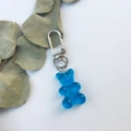 Detail of a blue translucent resin bear pendant with a secure silver metal keychain ring - Blue