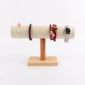 Macro detail of T-bar jewelry display stand with beige velvet and solid wood base - Large Cylinder: Beige Leather