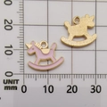 Pink enamel and gold rocking horse unicorn pendant with millimeter scale for size reference - Enamel Unicorn