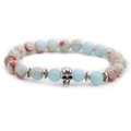 Macro detail of natural blue stone beads and a silver skull charm on a beaded bracelet - Skull