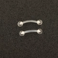 Detailed close-up of transparent acrylic curved barbells for eyebrow or lip piercing jewelry - Curved Barbell Eyebrow Stud (Single)