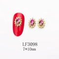 Detailed view of gold nail charm with purple oval stone and iridescent rhinestones - 3098 Purple Green Aurora Gold Base Oval (LF3098)