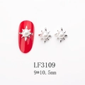 Detailed view of sunburst alloy nail art charm with white pearl on a red manicure - 3109 White Pearl Silver Base Starburst (LF3109)