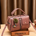 Dusty pink PU leather bowling bag with twin front pockets and decorative pompom charm - Dusty Pink