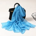 Elegant lightweight blue chiffon scarf draped on a black handbag for fashion styling - Blue