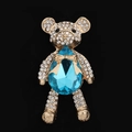 Macro shot of gold crystal bear accessory with sky blue gemstone and pavé rhinestones - Lake Blue