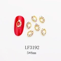 Golden nail art charms with rainbow rhinestones on red nail model, LF3192 5x8mm - AB Hollow Oval Style (3192) / 10 Pieces Pack