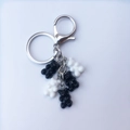 Detailed view of silver metal keychain rings with black and white resin gummy bear charms - Black and White