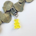 Detailed macro shot of a yellow resin gummy bear keychain with a silver metal clasp - Single Bear Pendant / Yellow