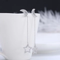 925 silver crescent moon and star tassel earrings with crystal detail on a white cup - Star Moon Long Tassel / Star Moon Tassel (SE62)