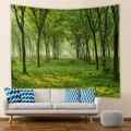 Detail of bohemian forest tapestry with sunlight landscape hanging above a modern sofa - 73X95CM (Brushed Fabric) / Dense Forest with Light Rays (GT100005)