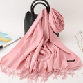 Elegant soft pink cashmere shawl scarf with long tassels draped on a black handbag - 200*70cm / Deep Pink