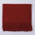 Solid dark red faux cashmere scarf with elegant tassels in a flat lay square fold - Burgundy