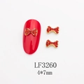 Détail du nœud rouge en strass pour nail art avec base en métal doré, 4x7mm - Base Dorée Strass Rouge (LF3260)