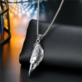 Detailed close-up of a carved silver eagle head pendant on a square box chain necklace - Eagle Head