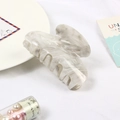 Macro shot of large marble pattern hair claw clip in white and grey acetate material - Beige Marble