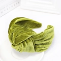 Macro detail of the green velvet fabric texture on this knotted wide-brim headband - Green
