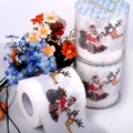 Detail view of printed toilet paper featuring Santa Claus and reindeer Christmas motifs - Santa Claus
