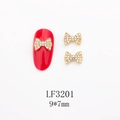 Macro view of gold bow nail art charm with white rhinestones on red nail, size 9x7mm - Gold Full Rhinestone Bow (LF3201)