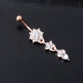Rose gold navel ring with crystal star and teardrop charms on a black background - Rose Gold