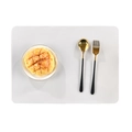 White rectangular silicone placemat with golden stainless steel cutlery on plain background - Beige Grey