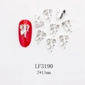 Close-up of 7x11mm silver leaf nail charms with rhinestones on a red manicure - Silver Textured Leaf Style (3190) / 10 Pieces Pack