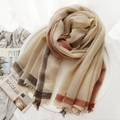 Beige wool scarf with red and brown plaid border and fringe on a white tray - Beige Plaid
