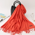 Vibrant orange cashmere scarf with tassel edges draped elegantly on a black leather handbag - 200*70cm / Brick Red