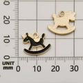 Unicorn rocking horse charm in black enamel and gold finish on measurement grid scale - Black Rocking Horse