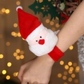 Festive Santa Claus plush slap bracelet on wrist with warm holiday light background - Plush Santa Claus