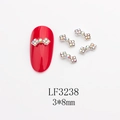 Détail macro de charmes de nœud argentés 3x8mm pour nail art avec strass - Base Argentée Strass AB (LF3238)