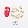 Détail de breloque nœud doré pour ongles avec strass blancs, taille 4x7mm, modèle LF3255 - Base Dorée Strass Blanc (LF3255)