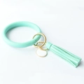 Detailed close-up of mint green PU leather keychain bangle with tassel and gold hardware - Mint Green