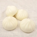 Set of four realistic steamed bun squishy toys on white linen for stress relief - PU Material / 7cm Pointed Bun