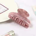 Detail of pink marble textured acetate hair claw clip with strong teeth and glossy finish - Pink Marble