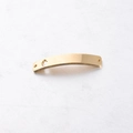 Macro view of golden stainless steel curved connector with heart cutout and brushed texture - Hamsa Hand Gold