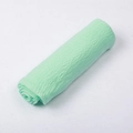 Solid light green crinkled voile scarf with fringed edges in a rolled display - Aqua Green