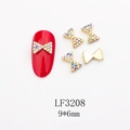 Détail macro de breloques nœud 9x6mm en alliage doré avec strass colorés pour ongles - Petit Nœud Doré avec Strass AB (LF3208)