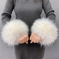 Close-up of fluffy white faux fur wrist cuffs worn over grey knit sleeves detail - White Black Jacquard