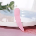 Single pink cosmetic spatula tool for facial creams, shown on a decorative tray - Pink