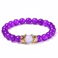 Purple beaded bracelet with a translucent white stone and gold zircon crown charms - Amethyst