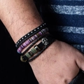 Close-up of bohemian leather wrap bracelets with vintage skull and bead details on wrist - N021 Skull Metal Rivet Leather Set